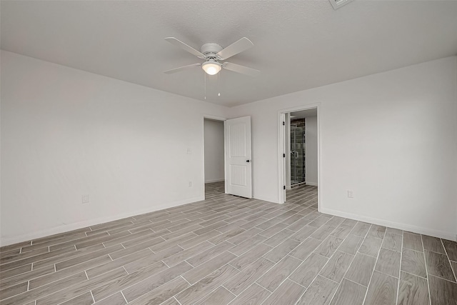 spare room with ceiling fan and a textured ceiling