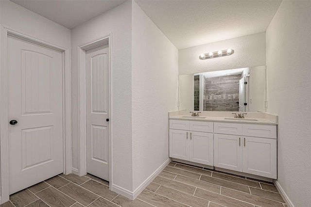 bathroom featuring a shower and vanity