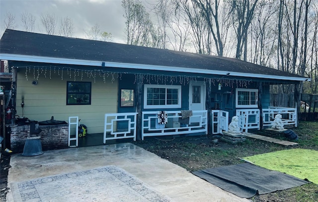 back of property featuring a porch