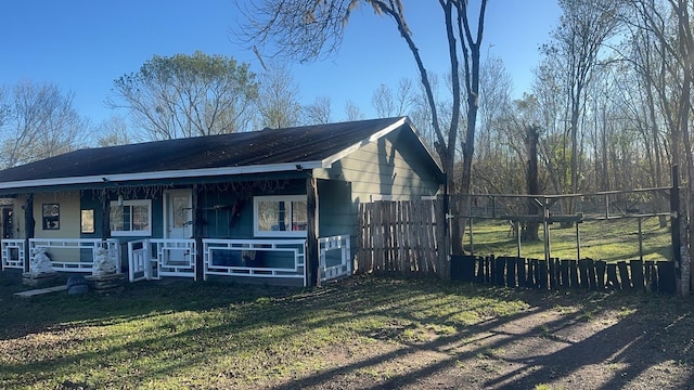 exterior space with covered porch and fence