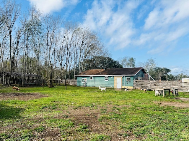 back of property with a lawn