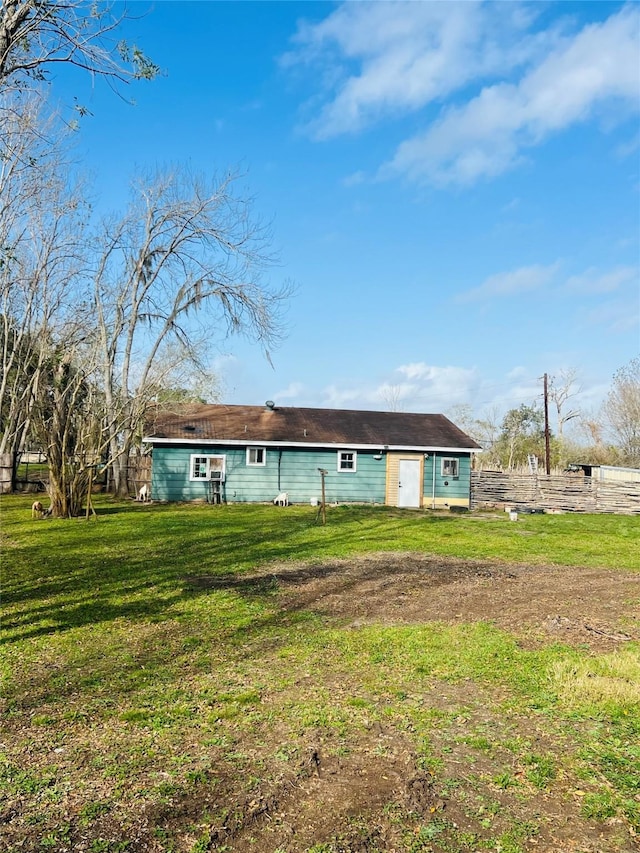 rear view of property with a yard