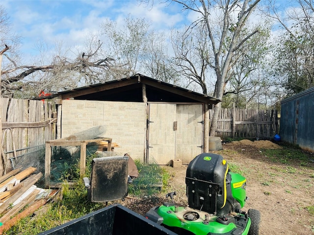 view of outdoor structure with an outbuilding and fence