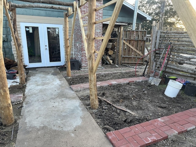 view of yard featuring french doors and fence