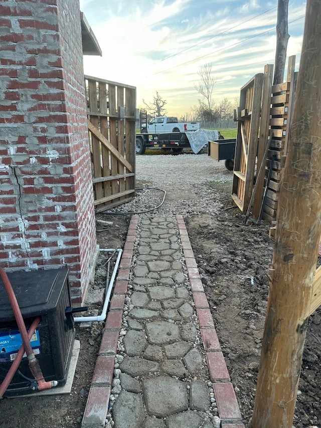 view of yard with fence and driveway