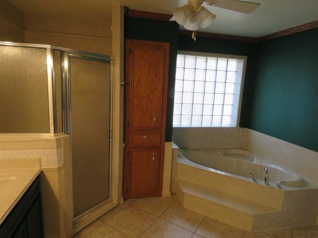 bathroom featuring vanity, ceiling fan, crown molding, tile patterned flooring, and shower with separate bathtub