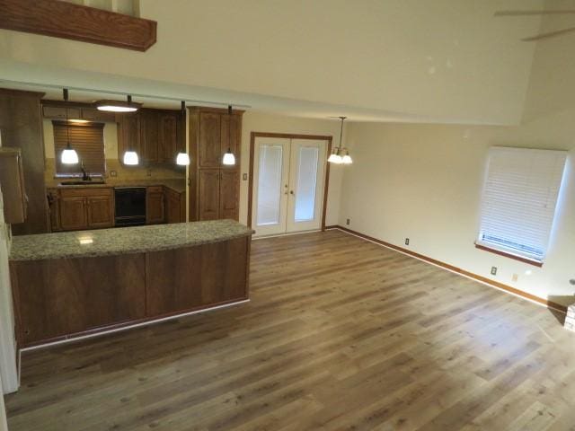 kitchen with dishwasher, dark hardwood / wood-style floors, sink, and french doors