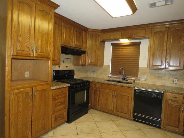 kitchen with decorative backsplash, sink, light tile patterned floors, and black appliances