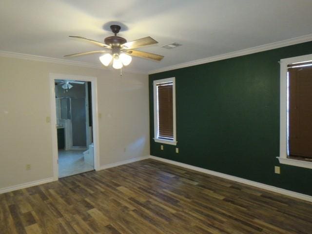 spare room featuring dark hardwood / wood-style floors, ceiling fan, and ornamental molding