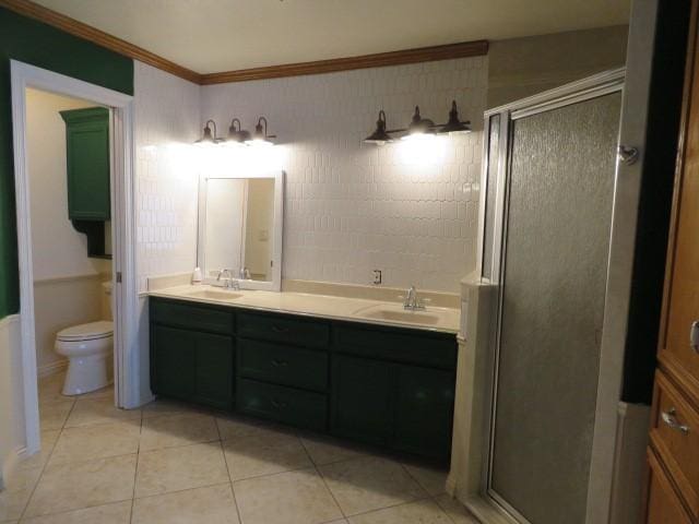 bathroom with tile patterned floors, an enclosed shower, vanity, crown molding, and toilet