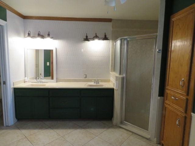 bathroom with crown molding, tile patterned flooring, vanity, and walk in shower