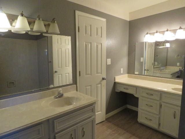 bathroom with hardwood / wood-style floors and vanity