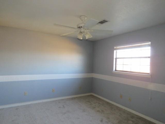 carpeted spare room with ceiling fan