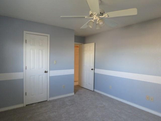 unfurnished bedroom featuring ceiling fan and carpet floors