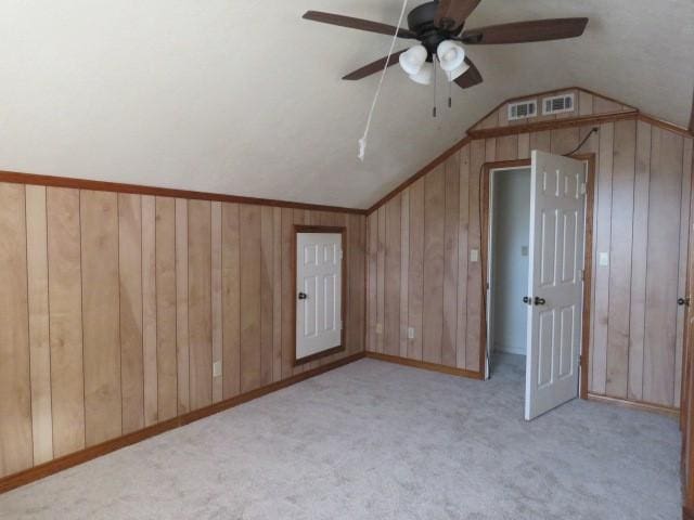 bonus room with ceiling fan, light colored carpet, and vaulted ceiling