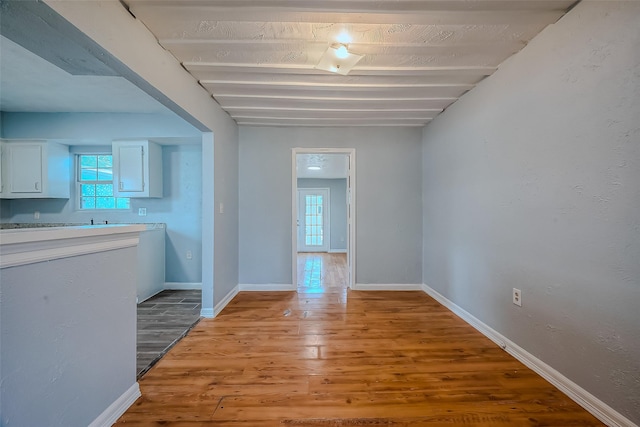 hallway with light hardwood / wood-style floors