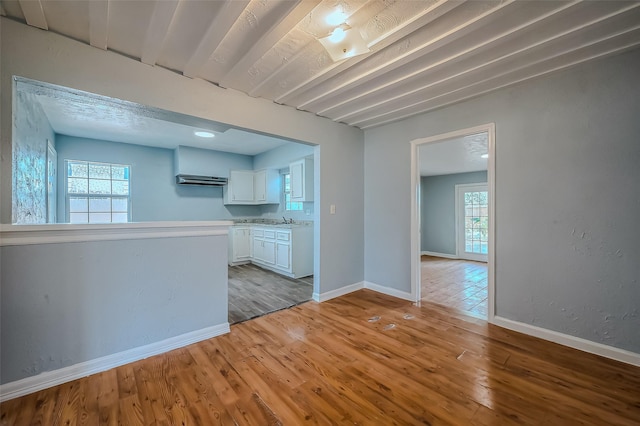 interior space with white cabinets and light wood-type flooring