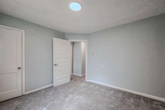 unfurnished bedroom with carpet and a textured ceiling