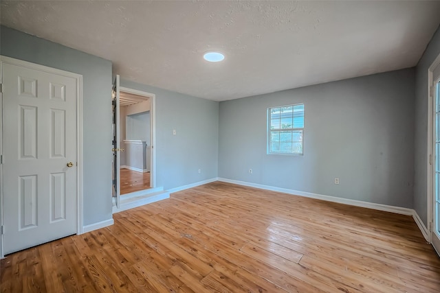 unfurnished bedroom with light wood-type flooring