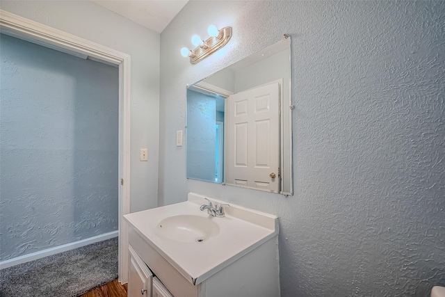 bathroom featuring wood-type flooring and vanity