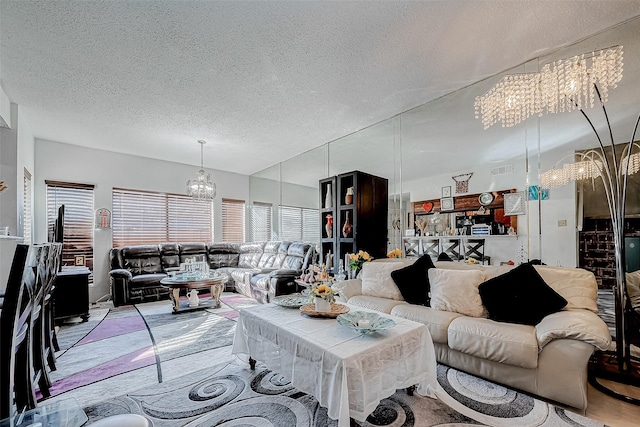 living room featuring a textured ceiling and an inviting chandelier