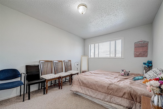 bedroom with light carpet and a textured ceiling