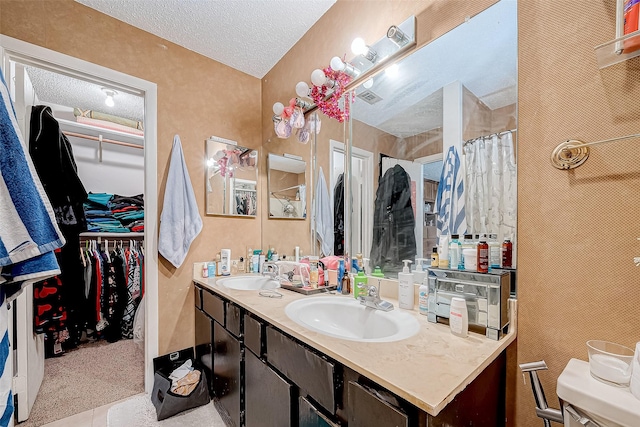 bathroom with tile patterned floors, vanity, curtained shower, and a textured ceiling