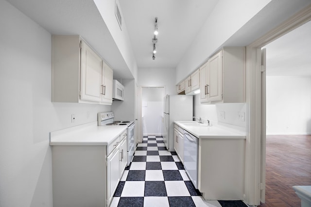 kitchen featuring white cabinets, white appliances, and sink