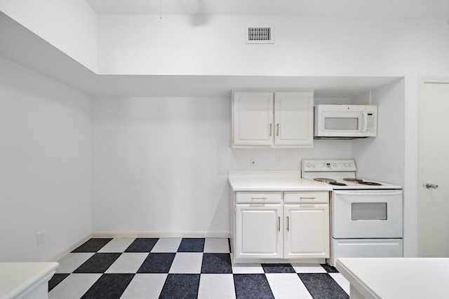 kitchen featuring white cabinets and white appliances