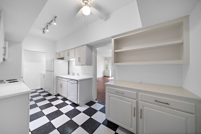 kitchen with white appliances, white cabinetry, ceiling fan, and sink