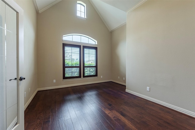 unfurnished room with high vaulted ceiling, a wealth of natural light, dark hardwood / wood-style flooring, and crown molding