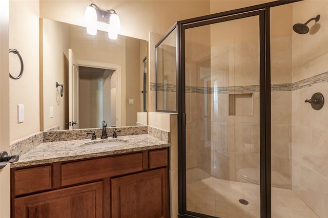 bathroom with an enclosed shower and vanity