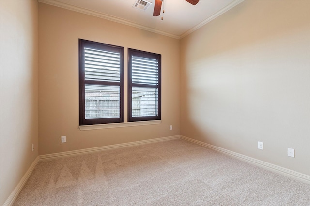 carpeted empty room featuring crown molding and ceiling fan