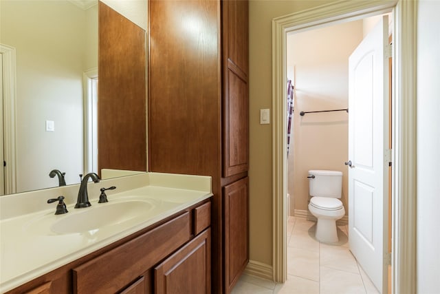 bathroom with vanity, toilet, and tile patterned floors