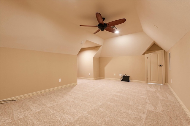 bonus room with ceiling fan, vaulted ceiling, and light colored carpet