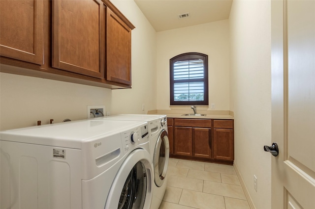 washroom with washer and dryer, cabinets, sink, and light tile patterned floors