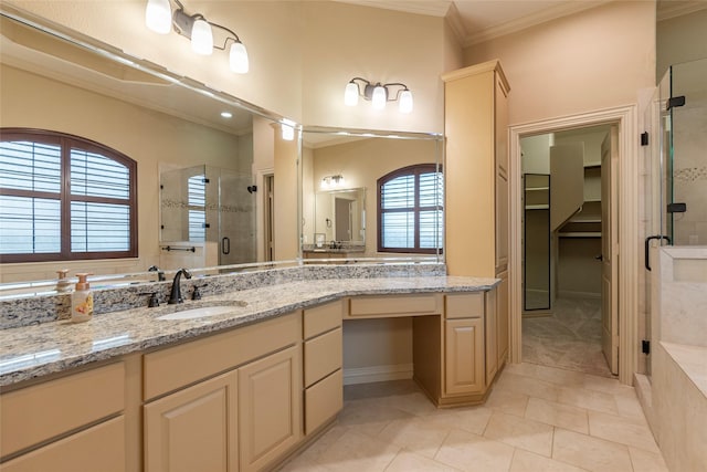 bathroom with vanity, crown molding, a shower with door, and tile patterned floors