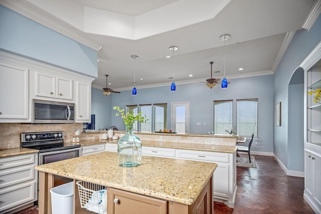 kitchen featuring white cabinetry, kitchen peninsula, decorative backsplash, and a center island