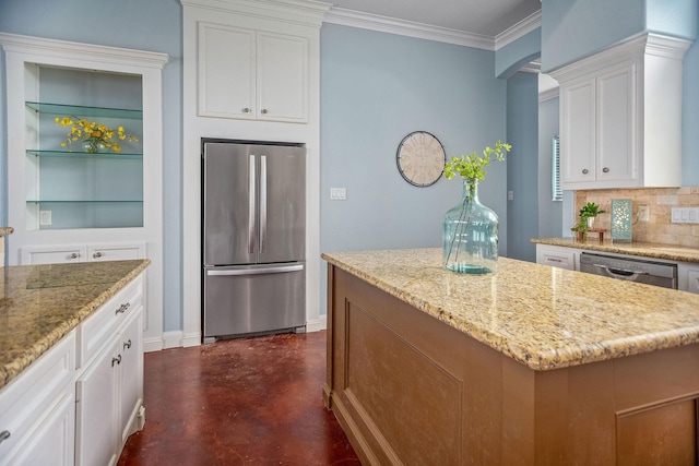 kitchen featuring white cabinetry, a kitchen island, light stone countertops, and appliances with stainless steel finishes