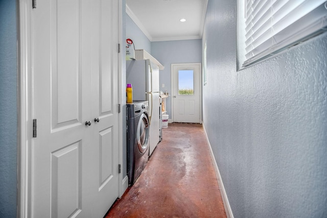 clothes washing area with separate washer and dryer and crown molding