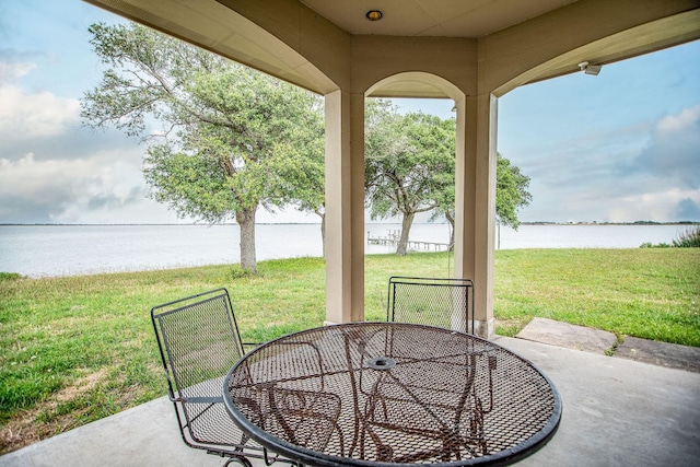 view of patio with a water view