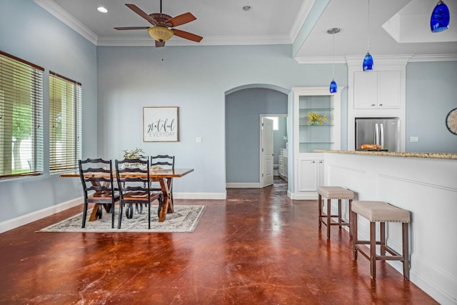 dining room with ceiling fan and crown molding