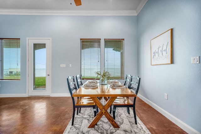 dining area featuring concrete flooring, ceiling fan, and crown molding