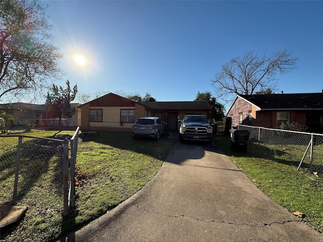 ranch-style house featuring a garage and a front yard