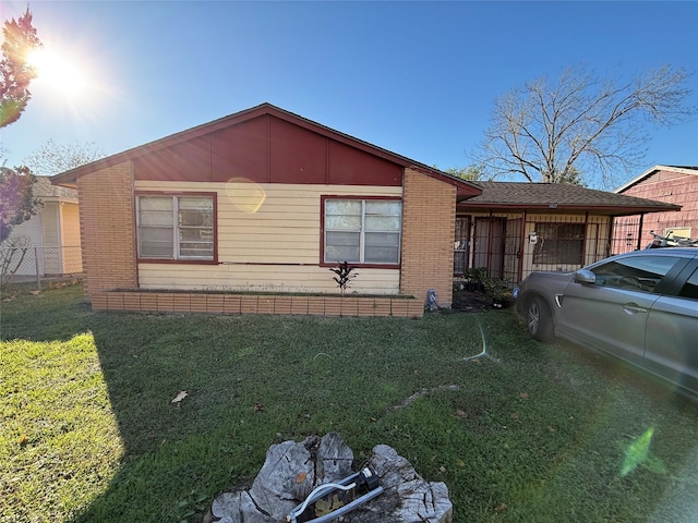 view of side of home featuring a yard