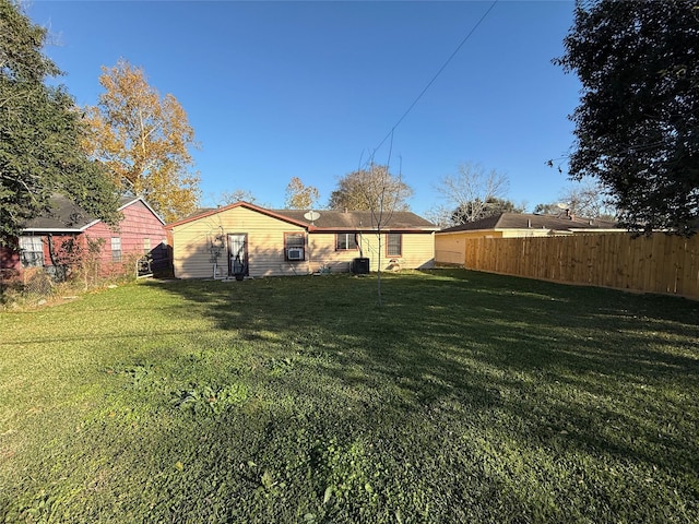 back of house featuring a lawn