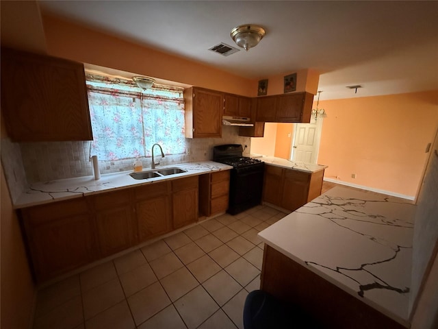 kitchen with light tile patterned floors, sink, black range with gas stovetop, kitchen peninsula, and tasteful backsplash