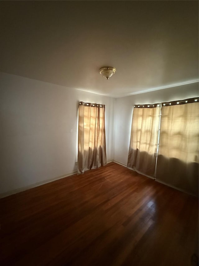 unfurnished room featuring dark hardwood / wood-style flooring