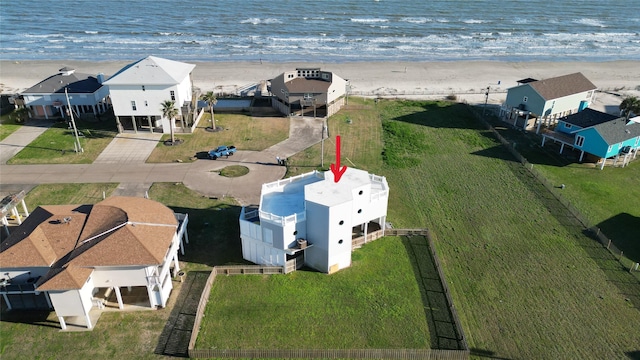 birds eye view of property featuring a beach view and a water view