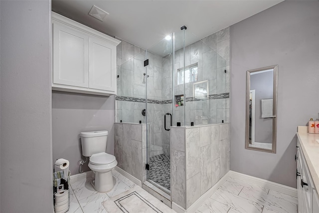 bathroom with vanity, toilet, and a shower with shower door